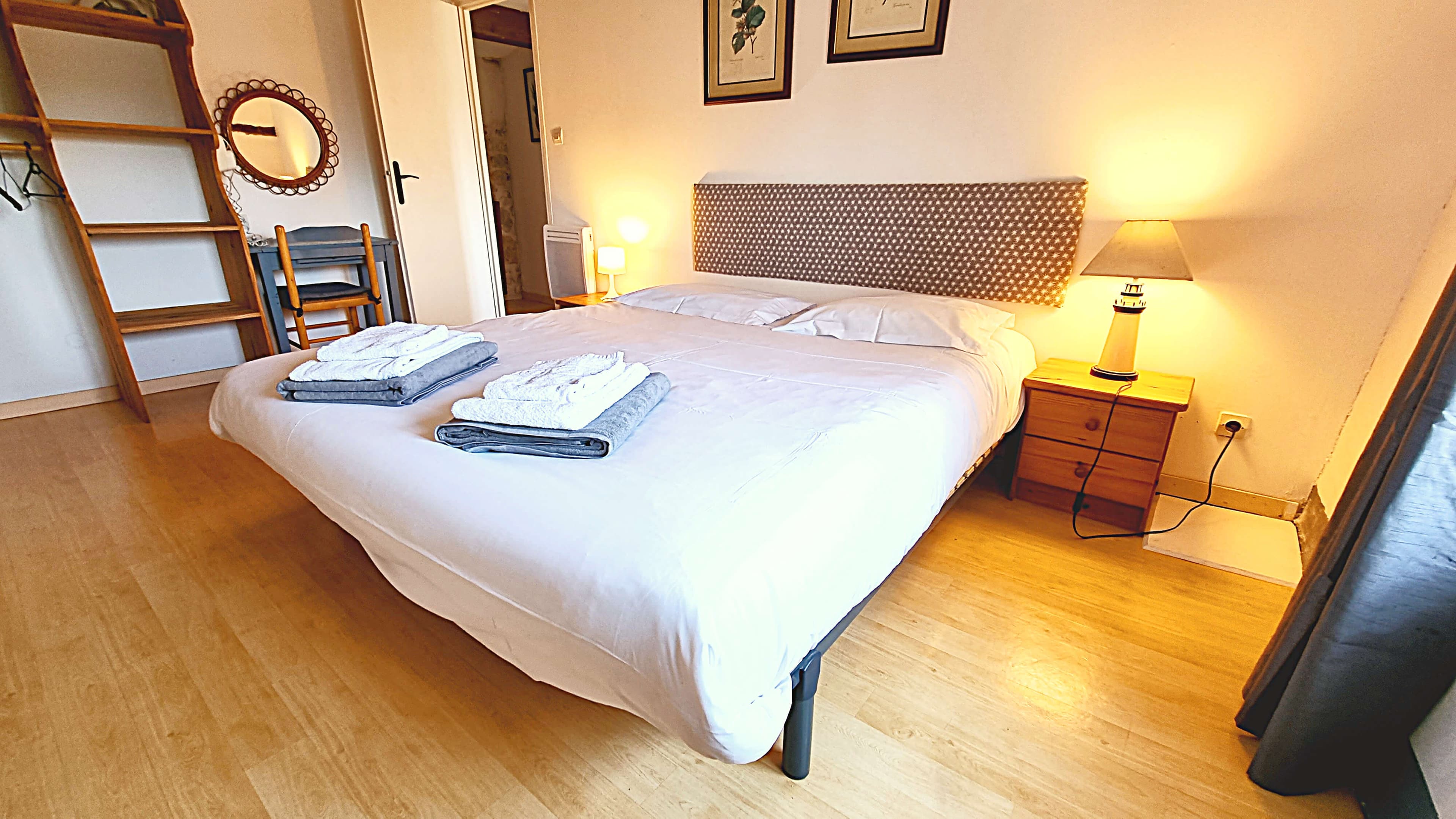 Double bedroom with wood flooring and clean decor