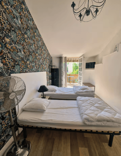 Elegant double bedroom with floral wallpaper