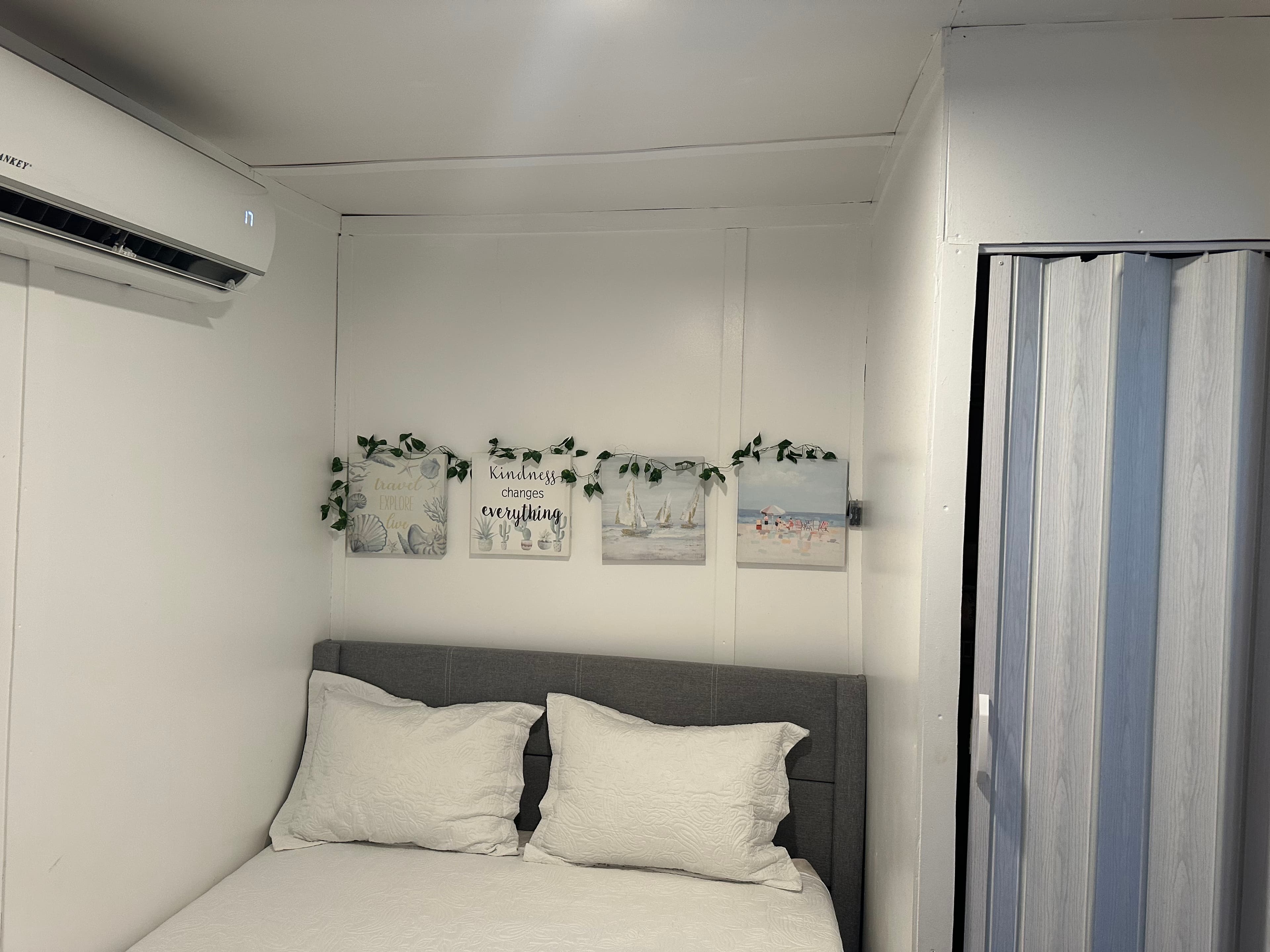 Queen bedroom with smart TV and air conditioner