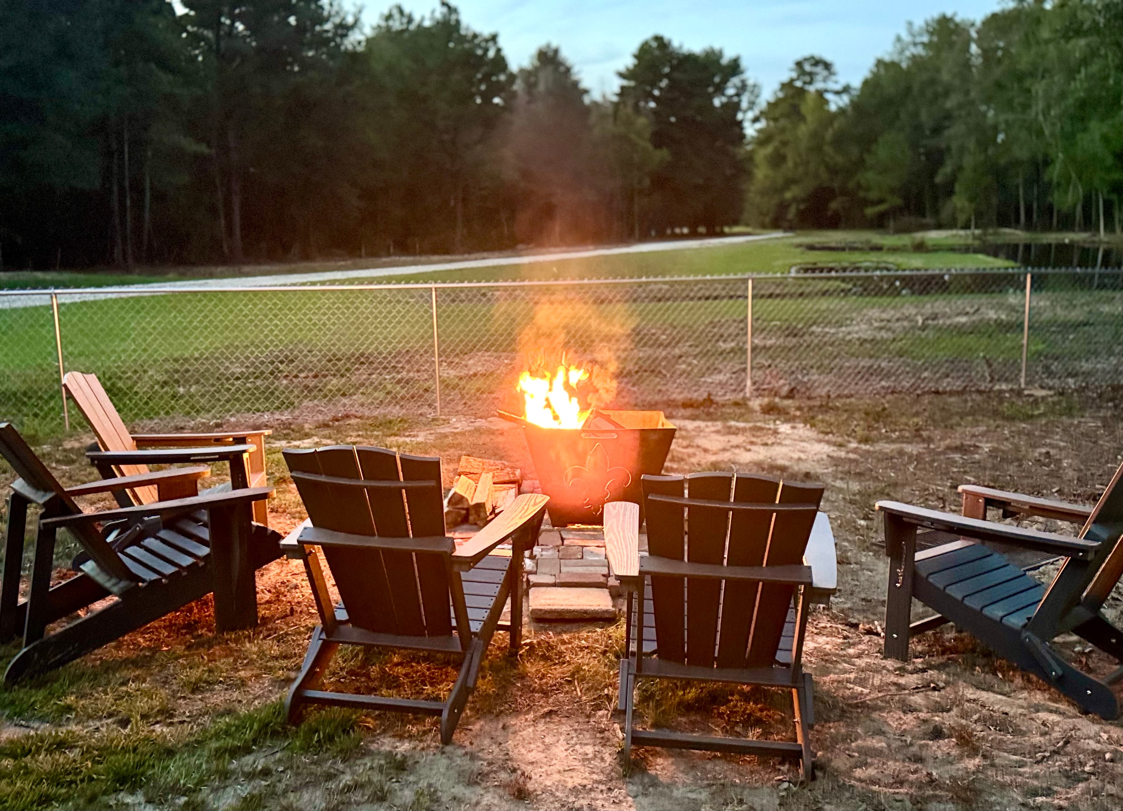 5 Adirondack chairs and a large fire pit 