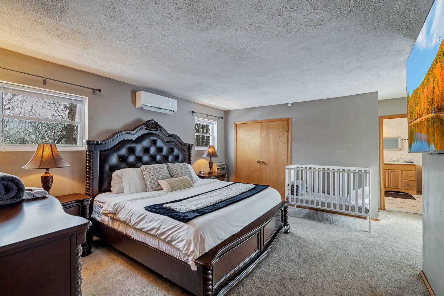 Spacious king bedroom with a large ensuite bath featuring a luxurious jetted tub. Step onto the deck