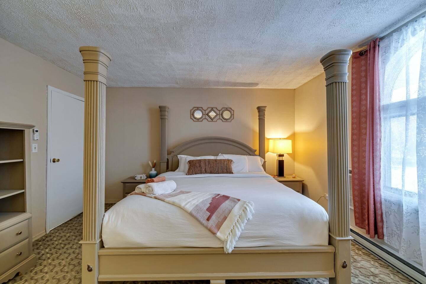 First-floor bedroom featuring a luxurious king bed with elegant decor, providing comfort and conveni