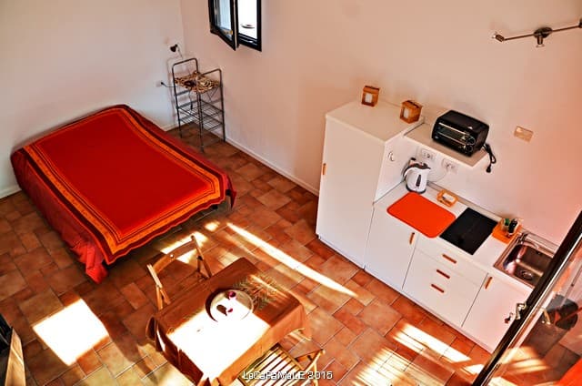 the room from upstairs, a tiny well organized space