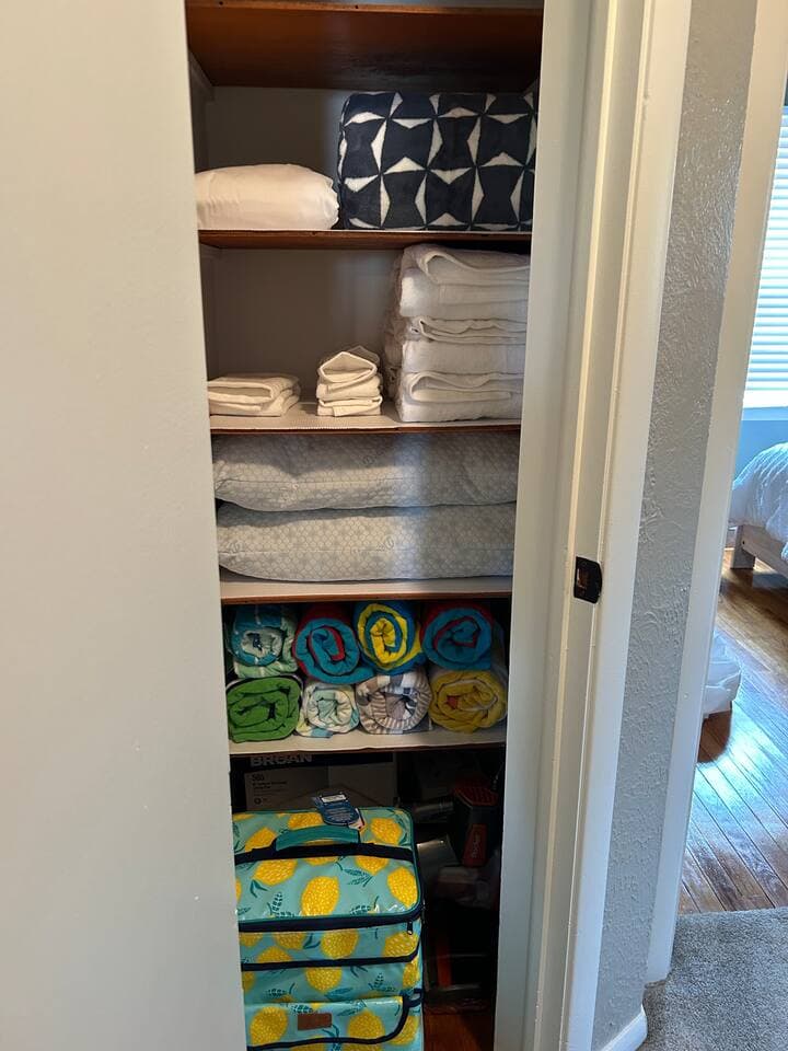 Linen Closet filled with extra towels, sheets for the sleeper sofa as well as beach towels and a cooler for the beach!  