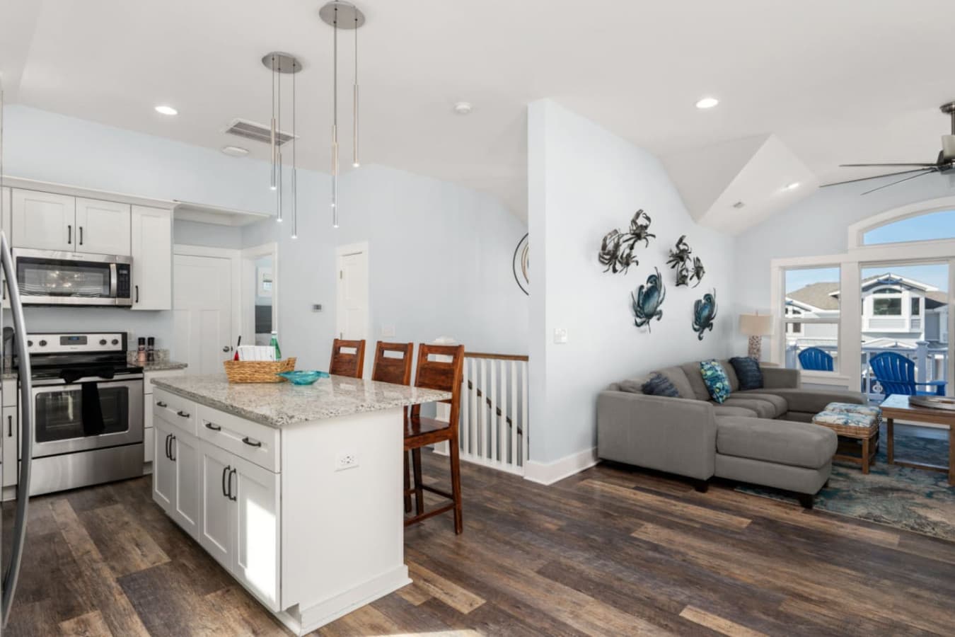 Open kitchen & living area w/ bright finishes, comfy seating & easy flow