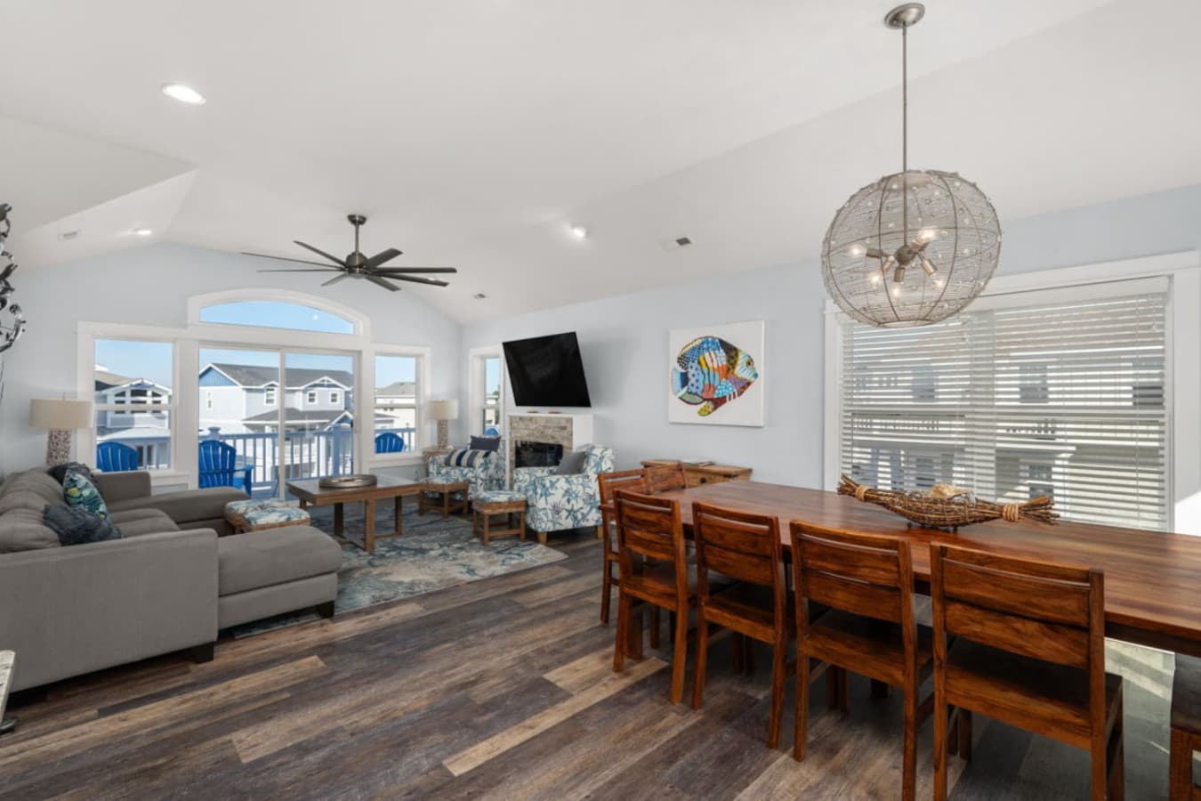 Spacious living room w/ coastal decor, plush sofas & ceiling fan comfort