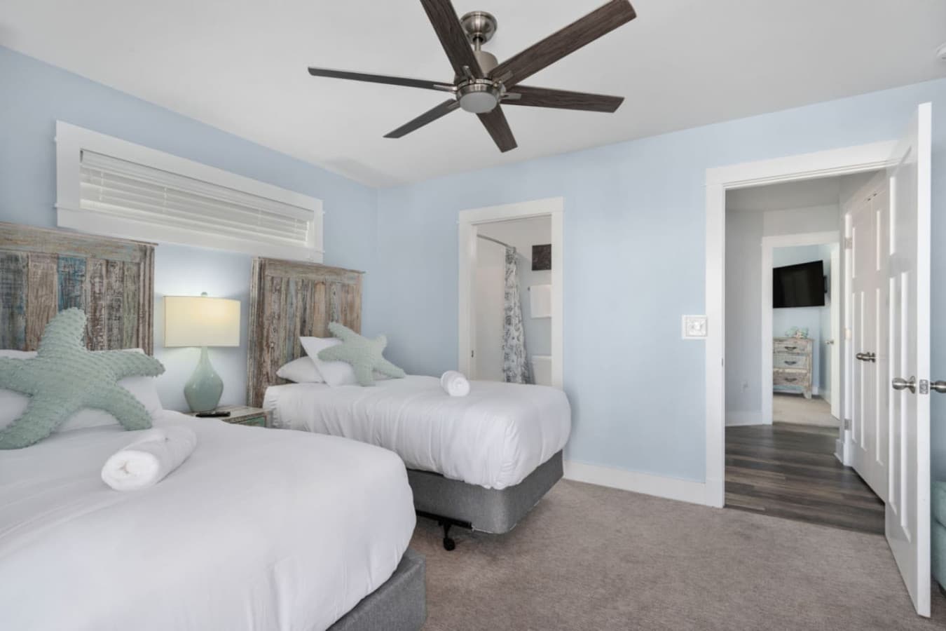 Family-friendly bedroom w/ multiple beds & a light, beachy palette