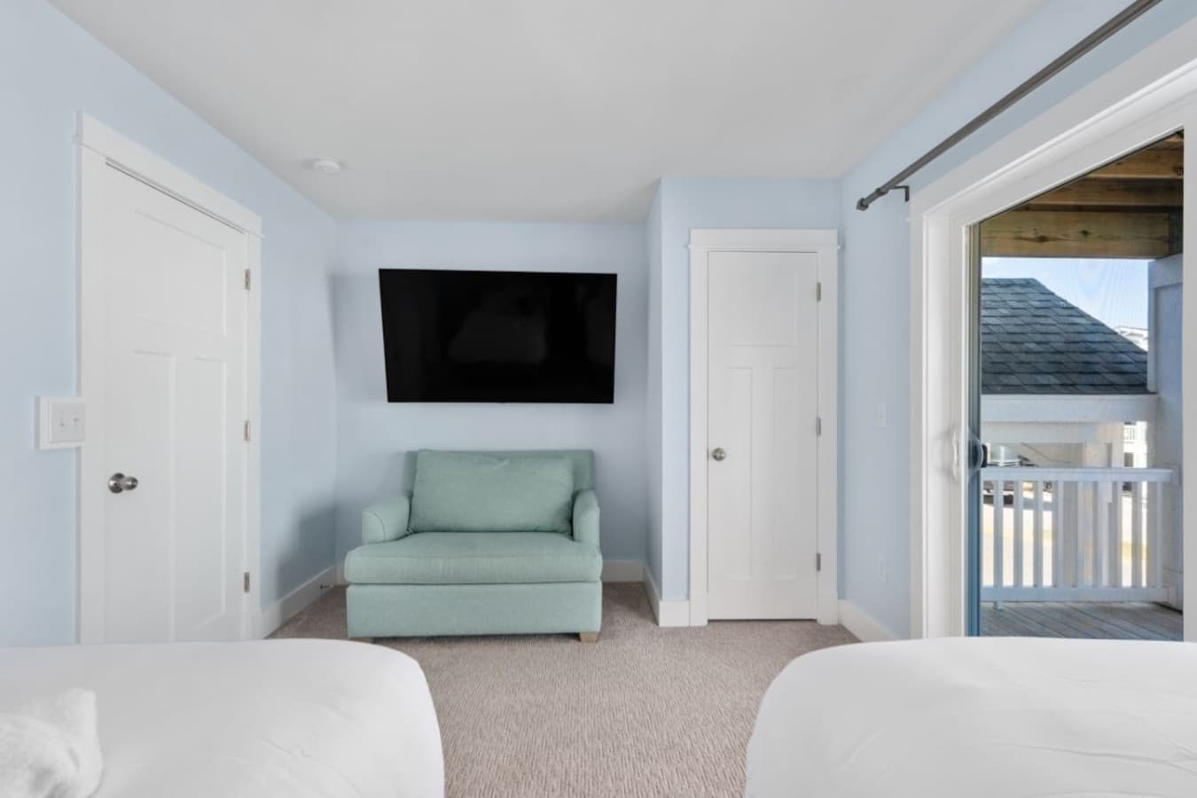 Peaceful bedroom w/ reading chair, TV & direct access to the balcony