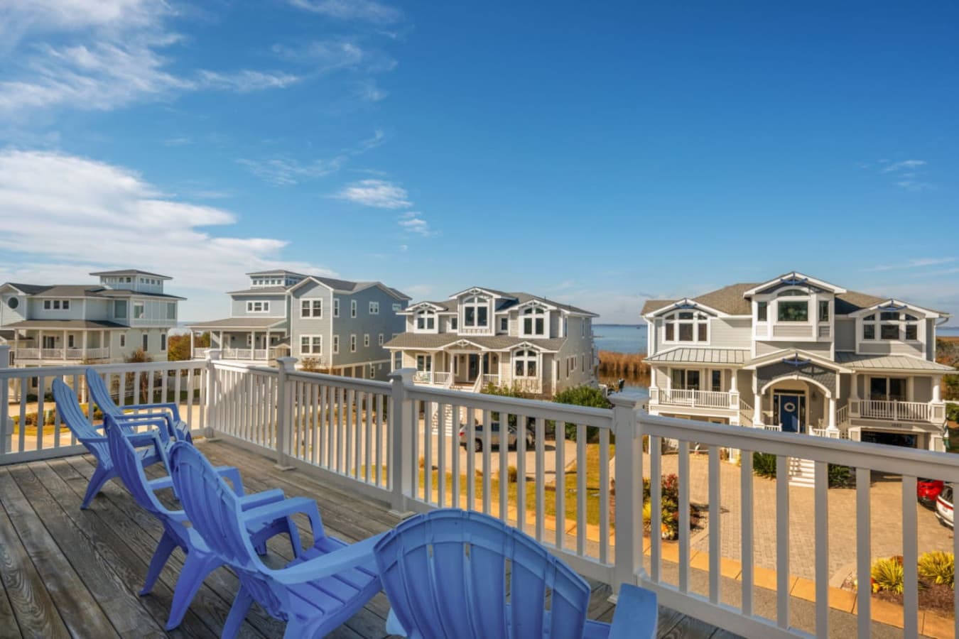 Sunny deck w/ seating to relax & take in the coastal neighborhood