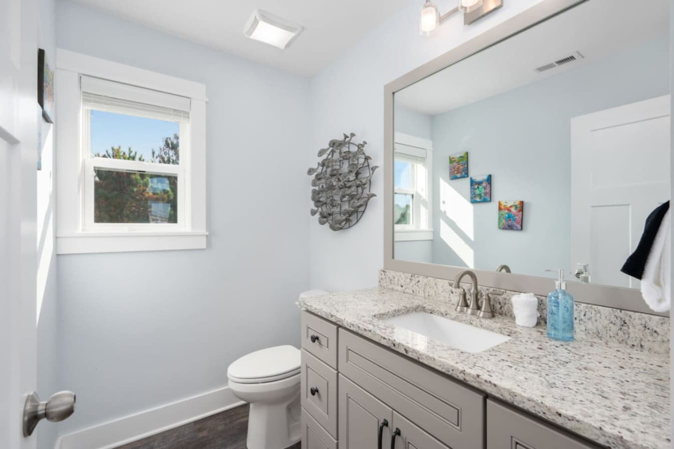 Fresh bathroom vanity w/ bright finishes, clean lines & a coastal touch