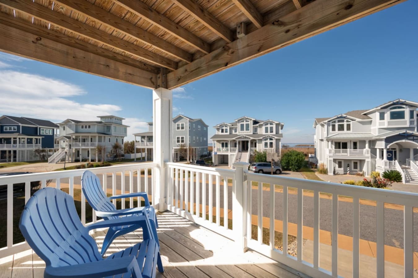 Covered deck w/ railing views, perfect for breezy mornings or sunset chats