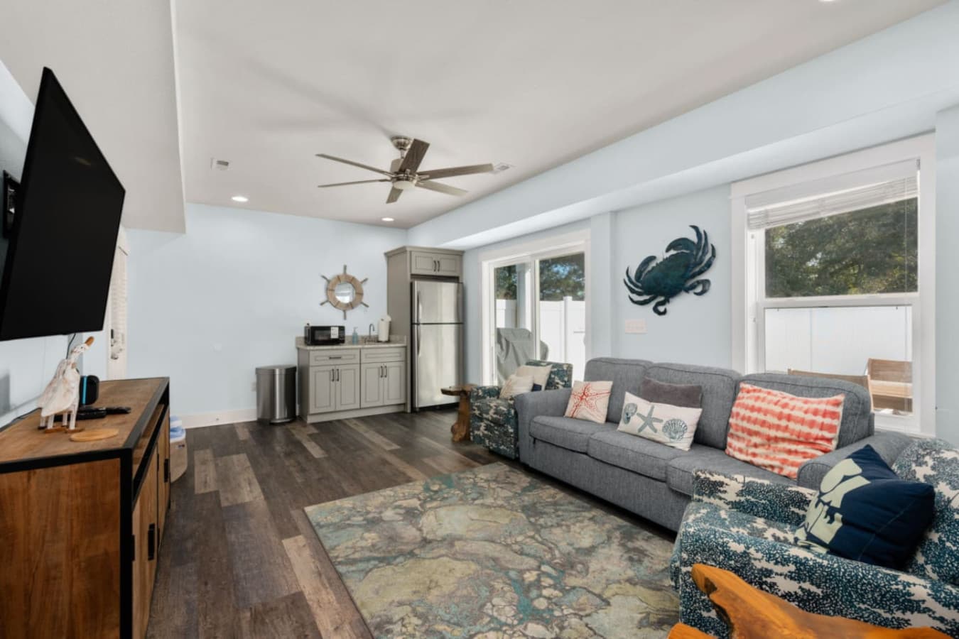 Spacious living area w/ sectional sofa, ceiling fan & easy indoor-outdoor flow