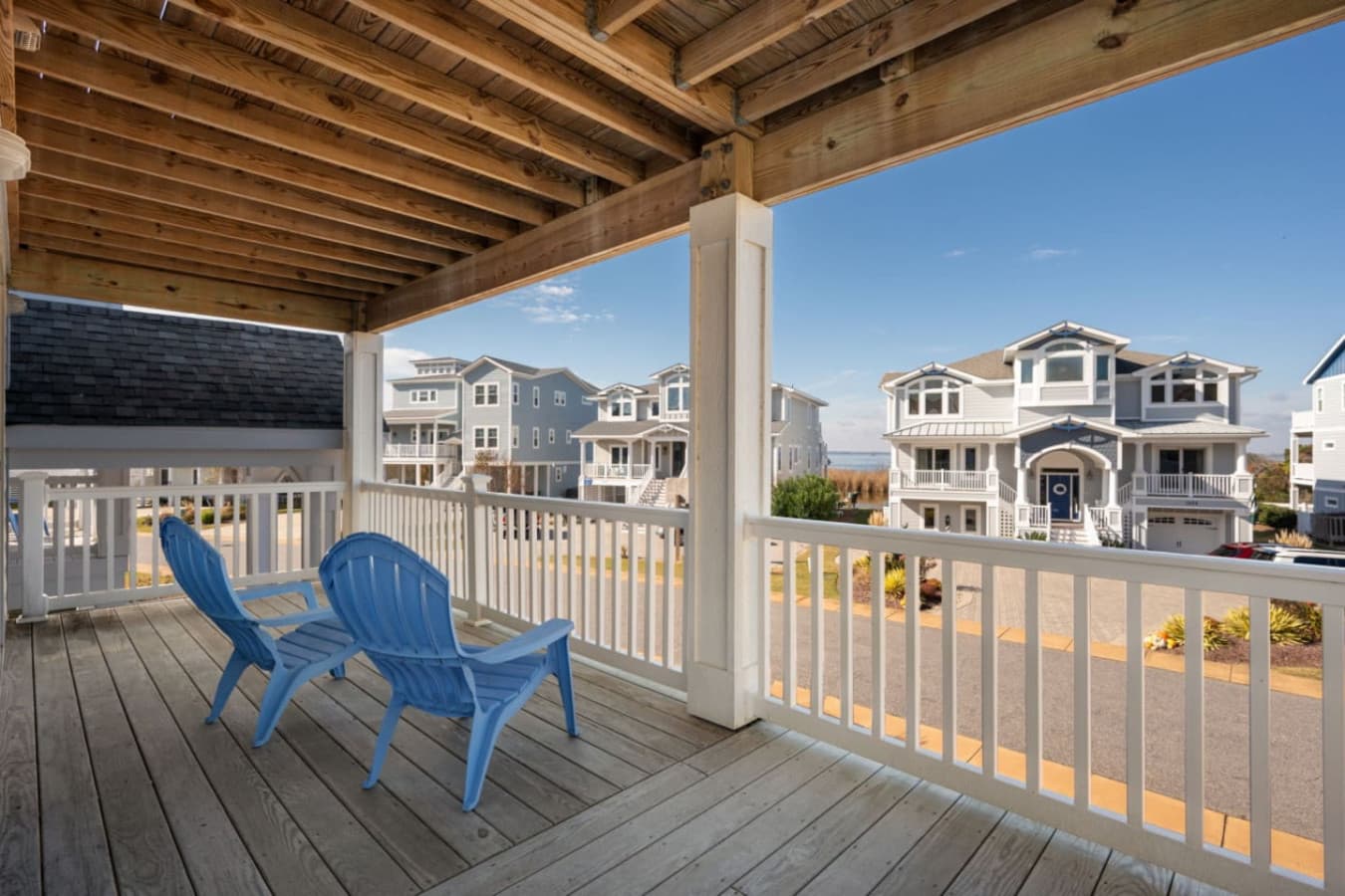 Covered deck w/ Adirondack chairs overlooking the beachside neighborhood