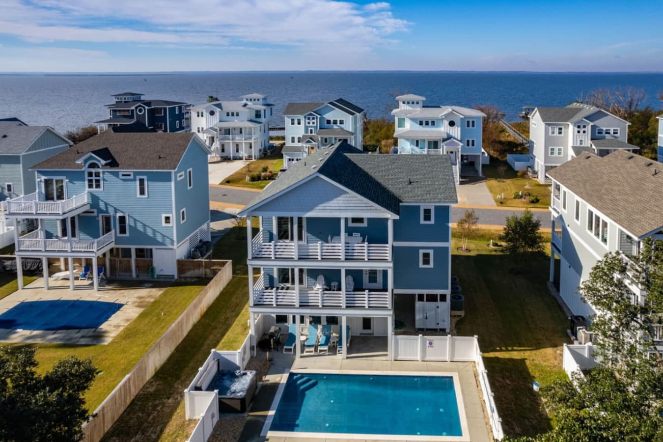 Aerial view highlighting the home among polished coastal-style residences.