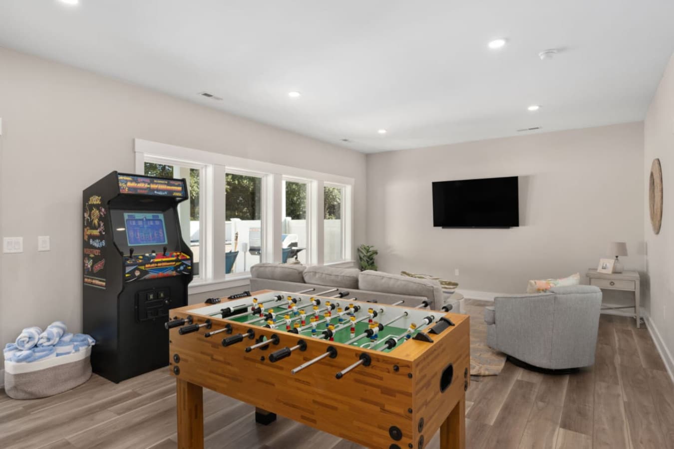 Fun-filled game room w/ foosball table & wall-mounted TV for friendly competition.