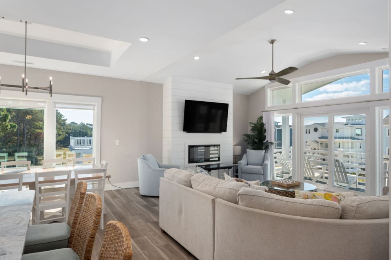 Open living area w/ cozy seating, high ceilings & sliding doors to the balcony.