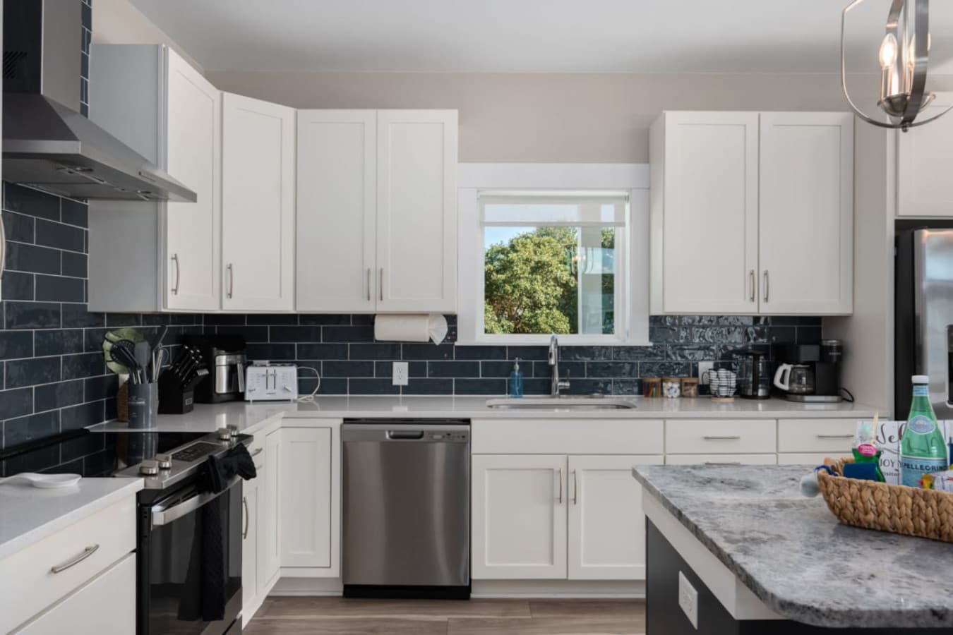 Clean-lined kitchen w/ ample counter space & bold backsplash details.