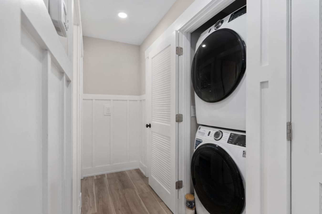 Convenient in-home laundry closet w/ stacked washer & dryer.