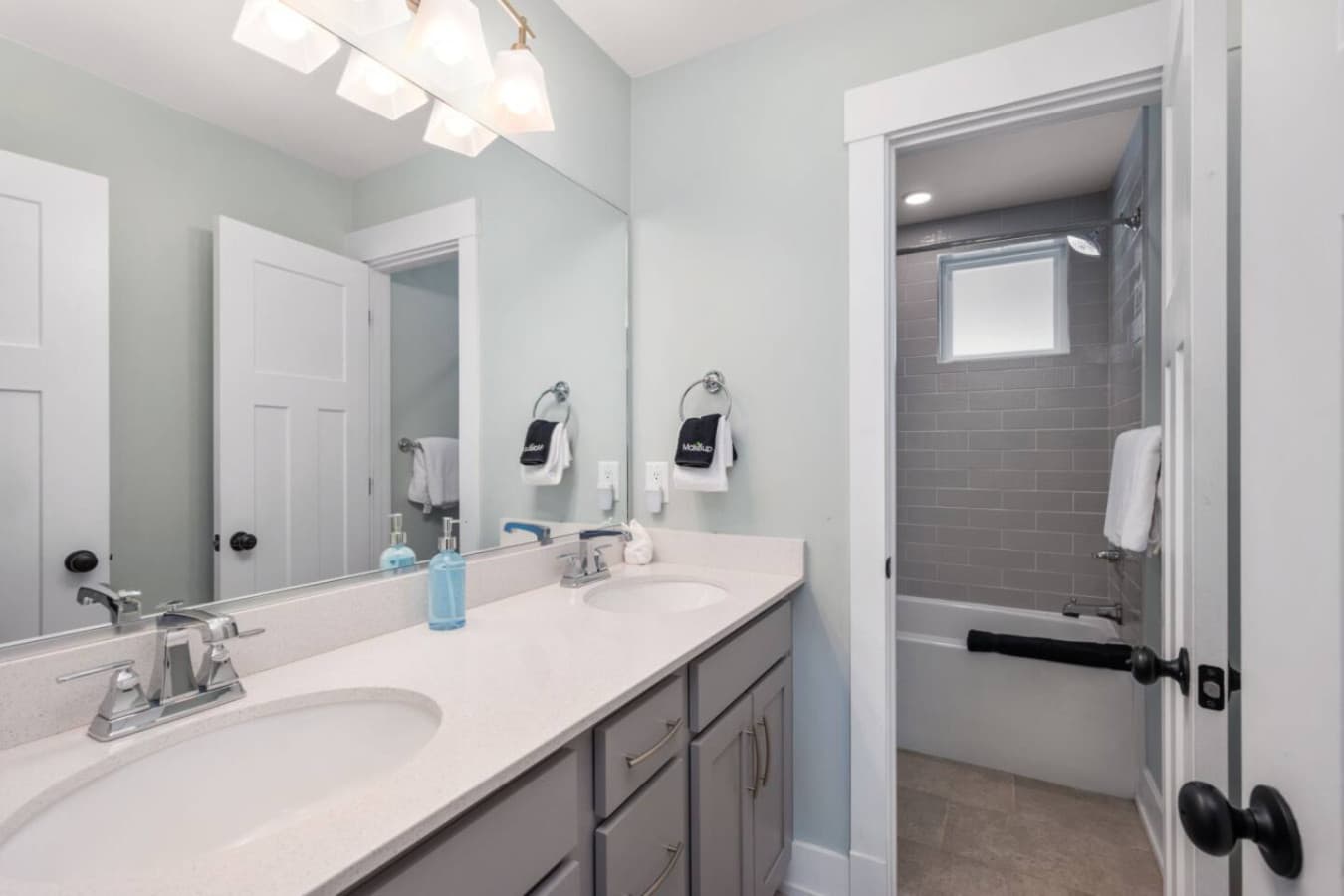 Clean hallway bath w/ spacious vanity & modern shower combo.