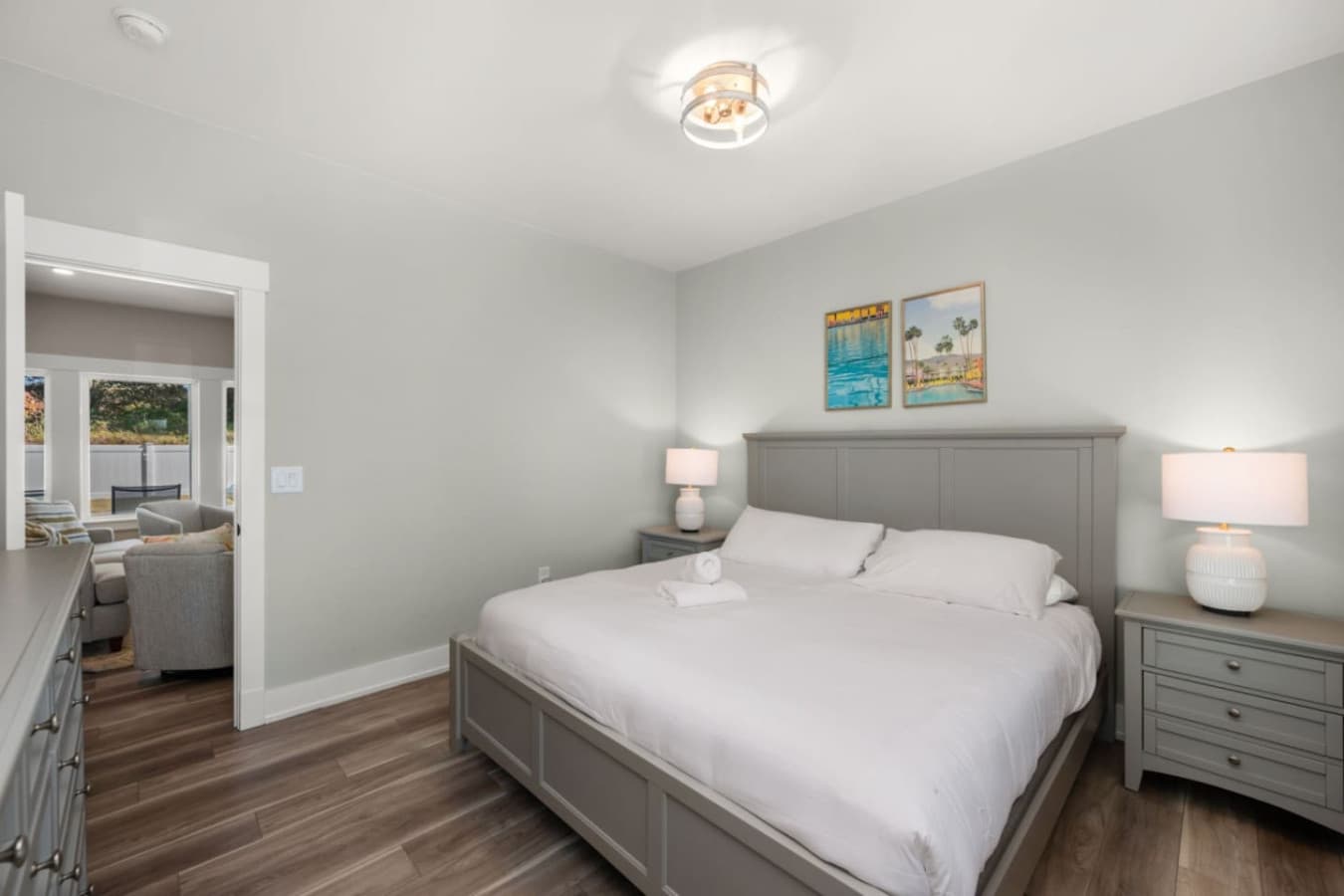 Cozy bedroom w/ soft lighting, neutral tones & a calm, restful feel.