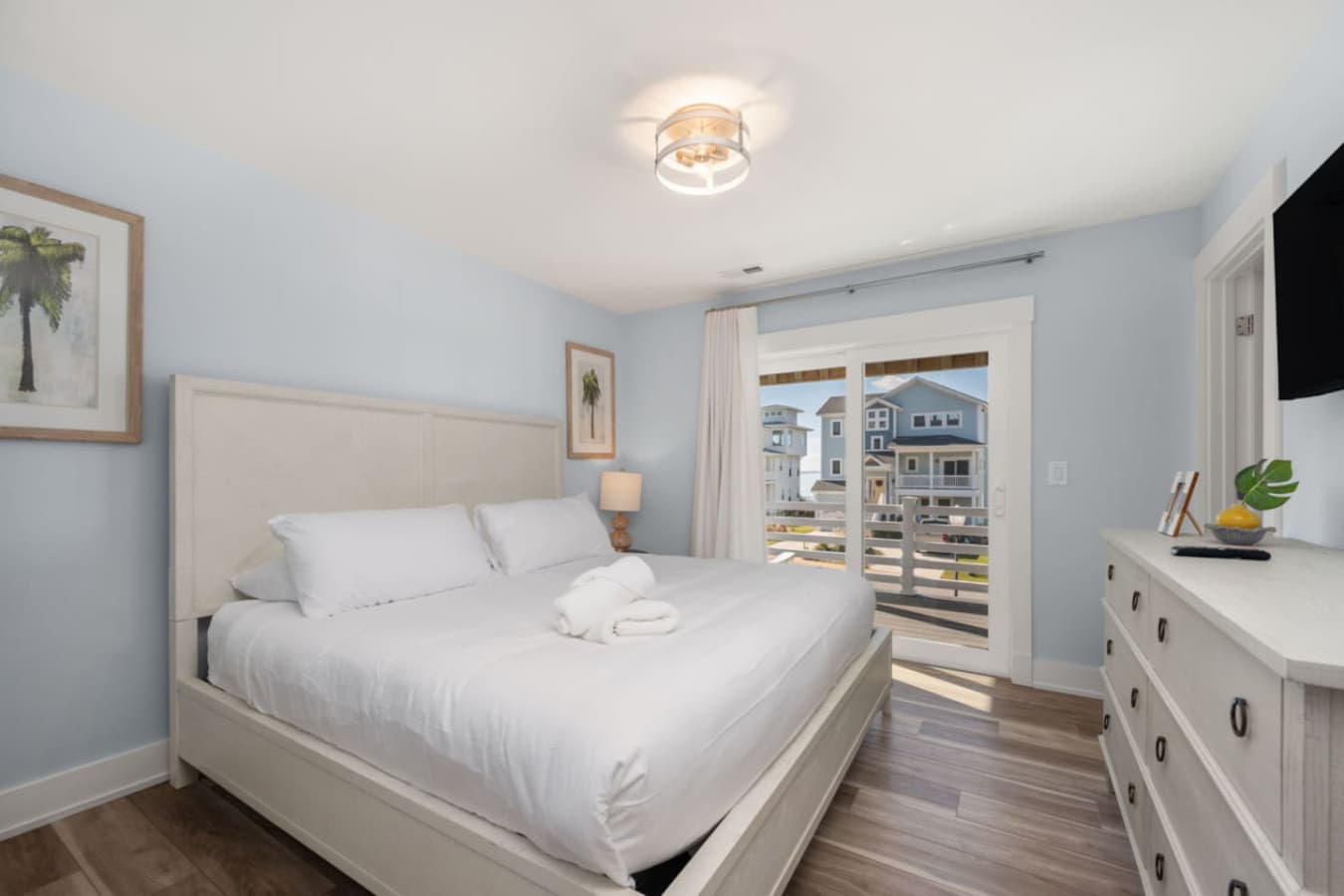 Light-filled bedroom w/ balcony access & simple, soothing decor.