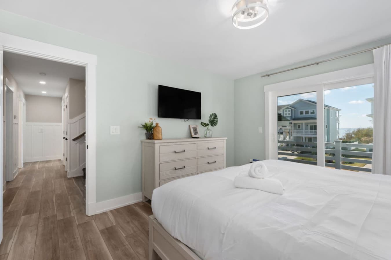 Comfortable bedroom w/ TV, storage & easy access to outdoor views.