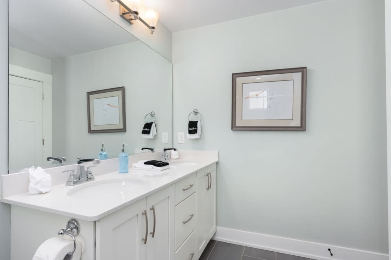 Bright private bath w/ double vanity, clean finishes & plenty of counter space.