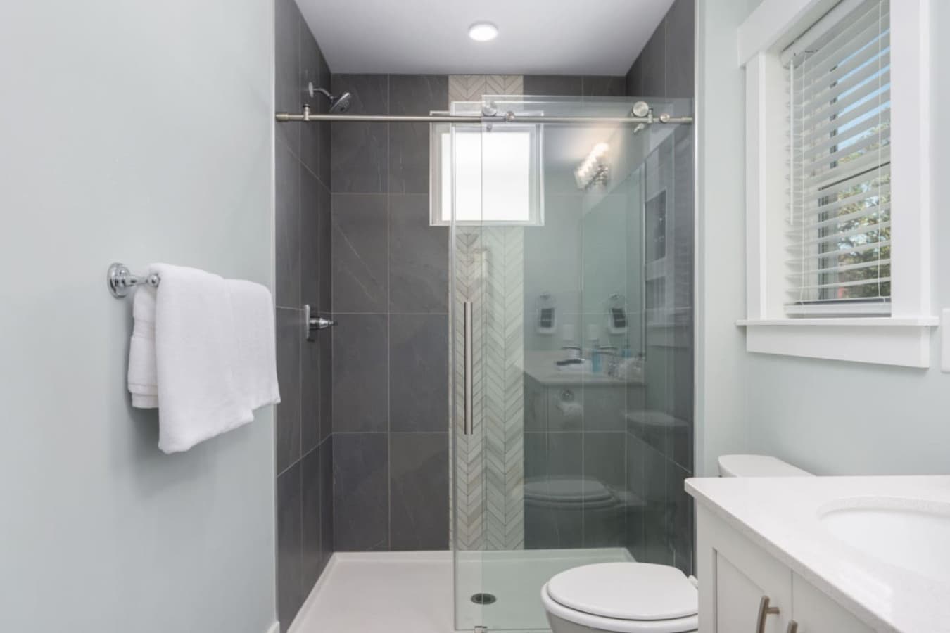 Glass walk-in shower w/ sleek tile for a refreshing, spa-like feel.