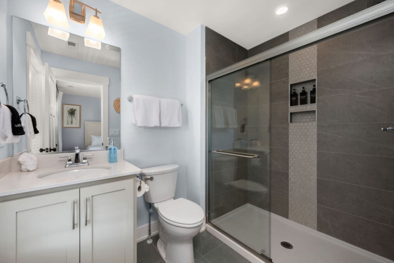 Modern ensuite bath w/ spacious shower & polished, coastal-inspired details.