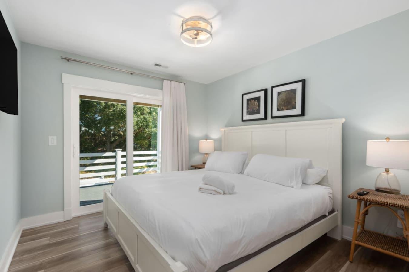 Airy bedroom w/ plush bed, simple decor & a peaceful vibe.