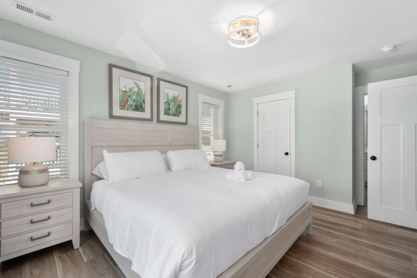 Light-filled bedroom w/ clean lines, ceiling fan & cozy layout.