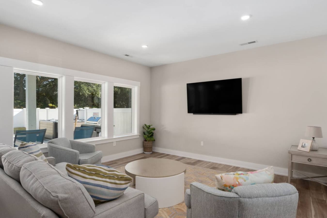 Open living area w/ sofa seating, TV & easy indoor-outdoor flow.