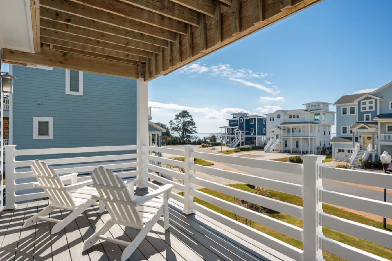 Upper balcony w/ shade, seating & a breezy spot to relax outdoors.