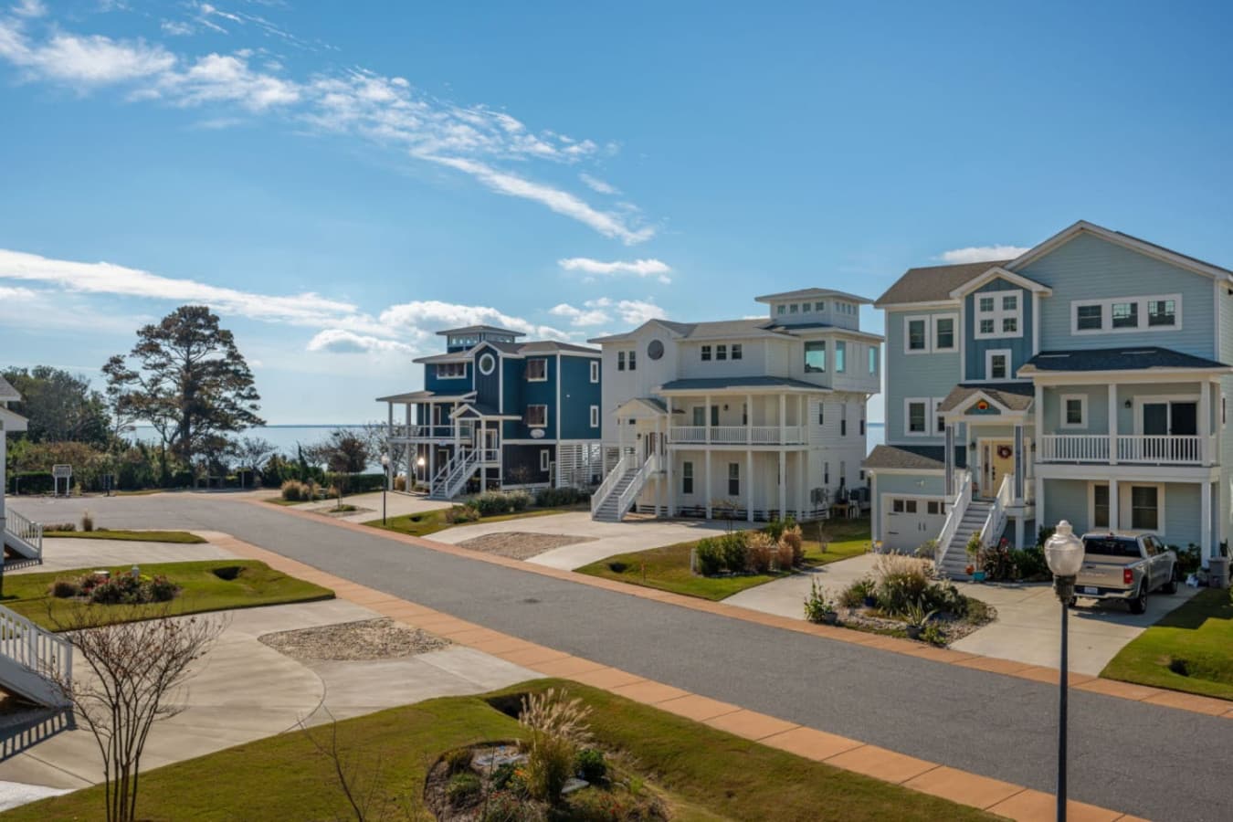 Quiet community street lined w/ coastal homes & the sound visible at the far end.