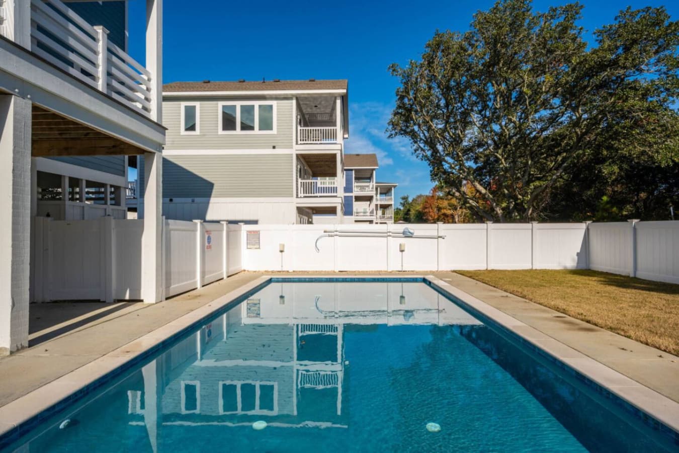 Private pool w/ fenced surround, sunny deck & lawn just off the home's lower level.