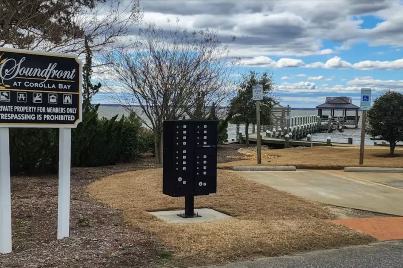 Soundfront at Corolla Bay community entrance w/ mailboxes & the pier out on the water beyond.