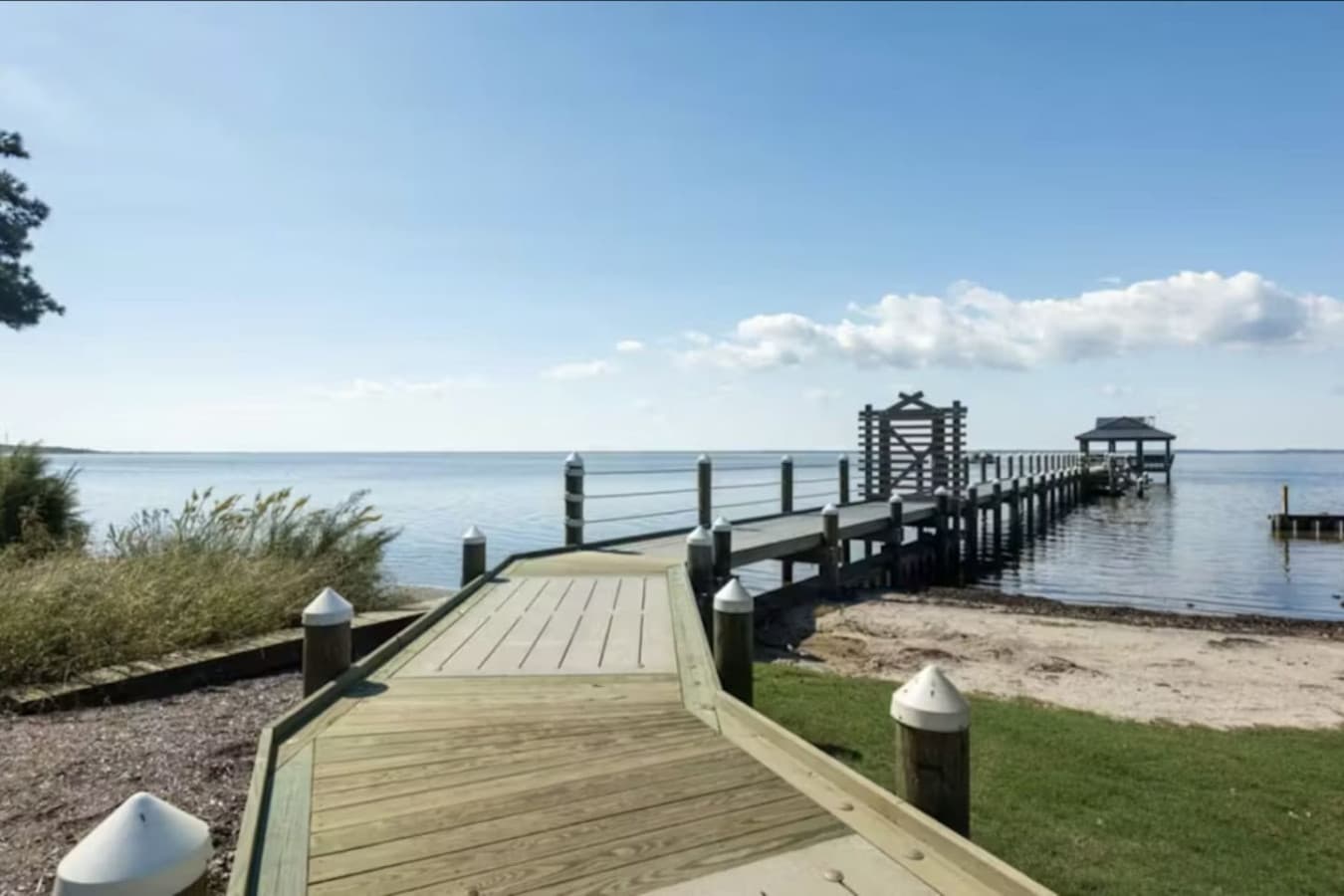 Wooden boardwalk leading out to the community pier & gazebo over the sound.