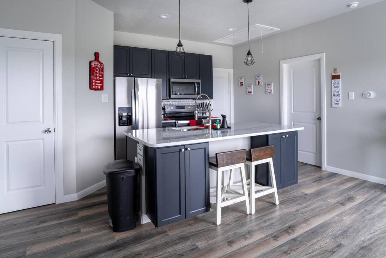 Fully stocked kitchen with new appliances and cookware.