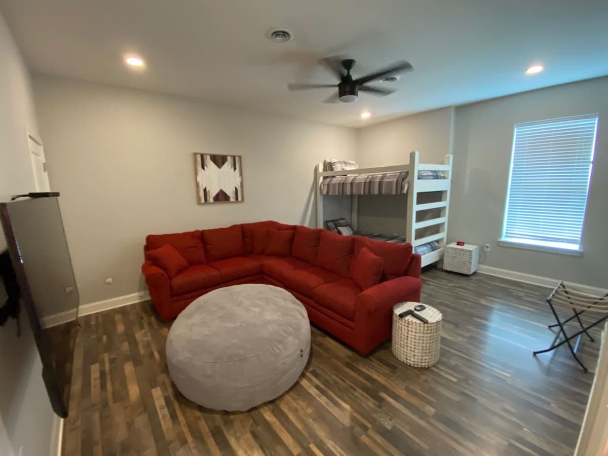 Large kid room/2nd living room with 2 twin bunk beds.