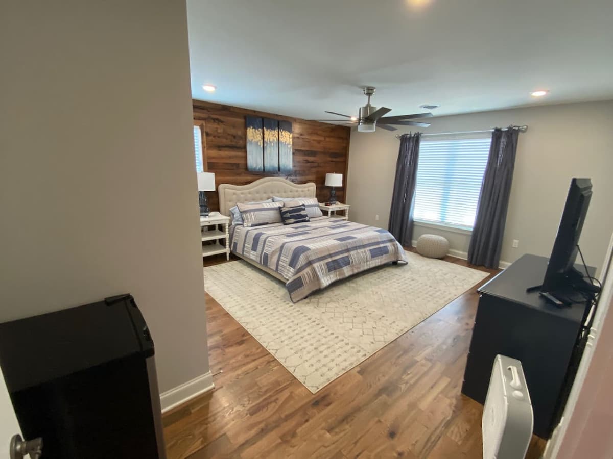 Kind bedroom on second level with ensuite bath and small refrigerator.