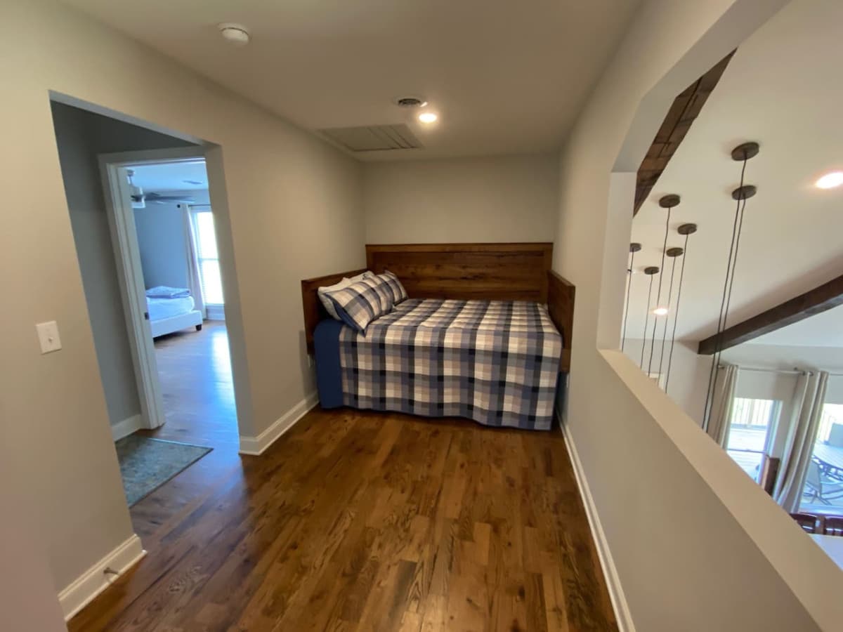 King loft bed outside of a king and queen bedroom upstairs.