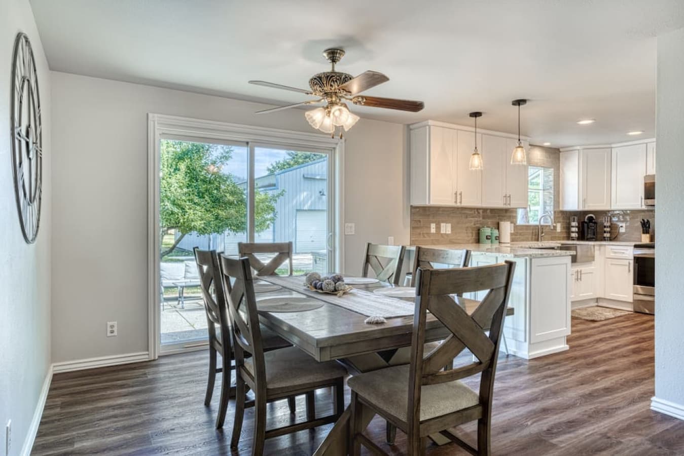 Slider doors by dining table leading to backyard & hot tub area