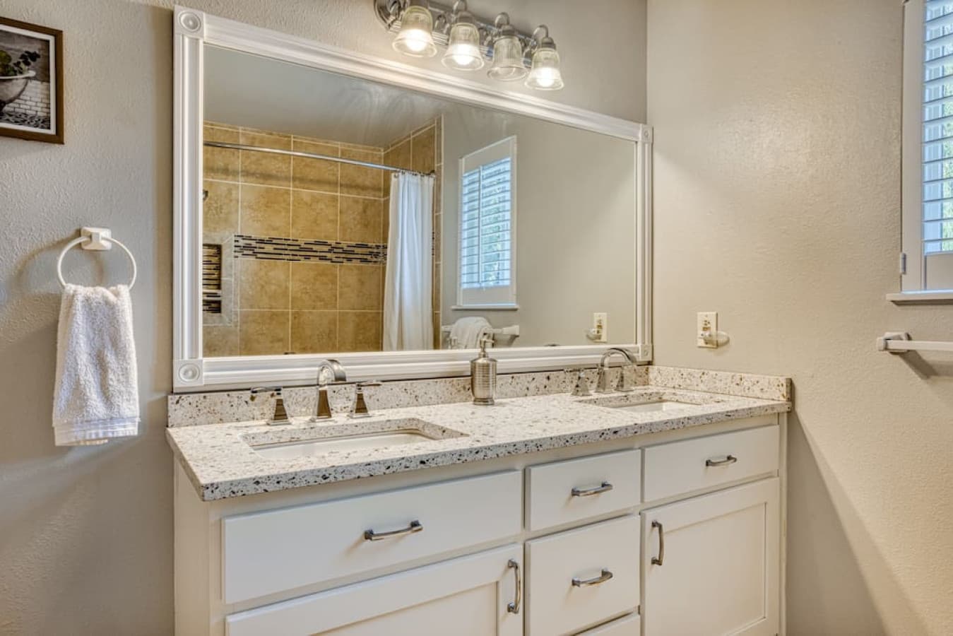 Double sink vanity in full bathroom on top floor