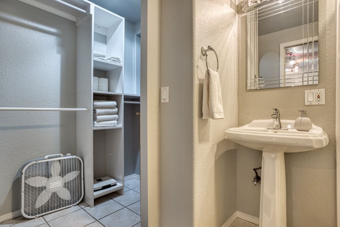 Large walk-in closet inside private full bathroom in king bedroom on bottom floor.