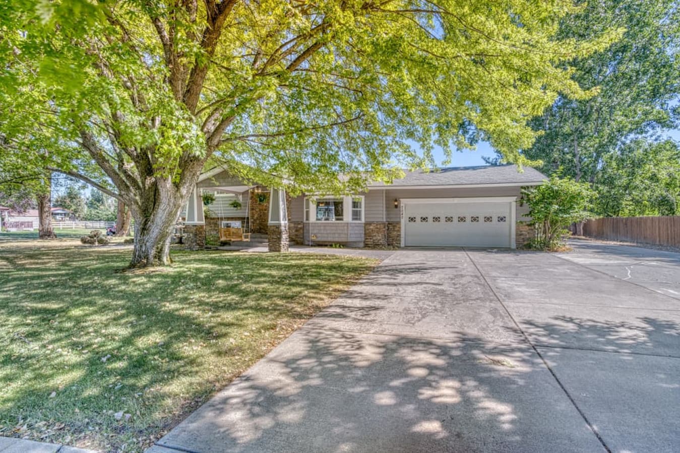 Large driveway that continues around the right side of the house to the backyard area