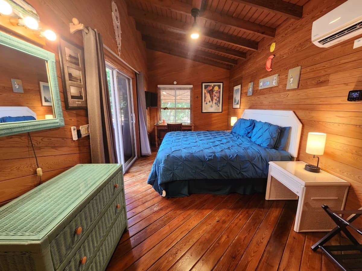 Main floor end bedroom with new king pillow top mattress and desk. Walk out slider to hot tub & deck!