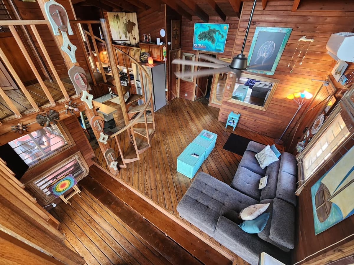 Living room with pull out queen sleeper sofa & queen bean bag chair! Enjoy the hammock & tons of local art pieces that decorate the walls to truly set the ISLAND VIBE!