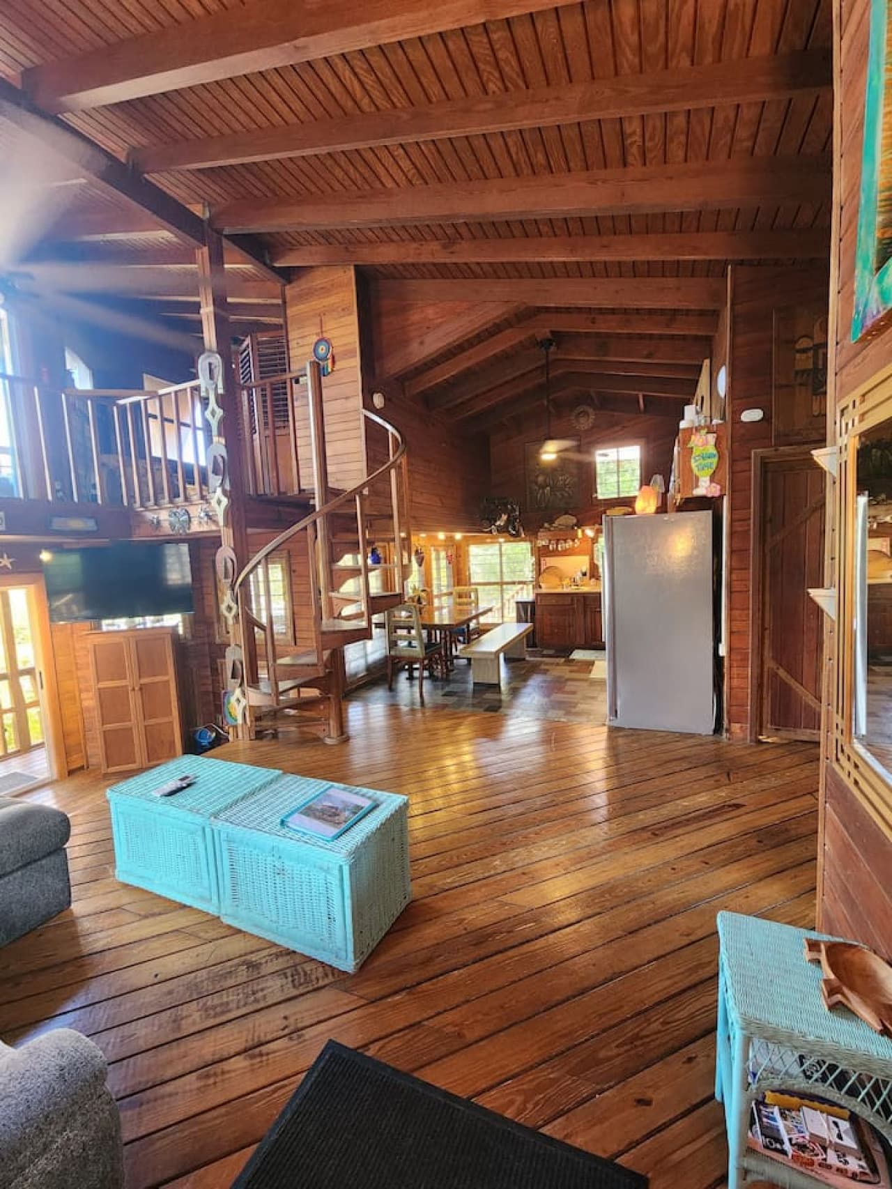 Living room with pull out queen sleeper sofa & queen bean bag chair! Tons of local art pieces decorate the walls to truly set the ISLAND VIBE!