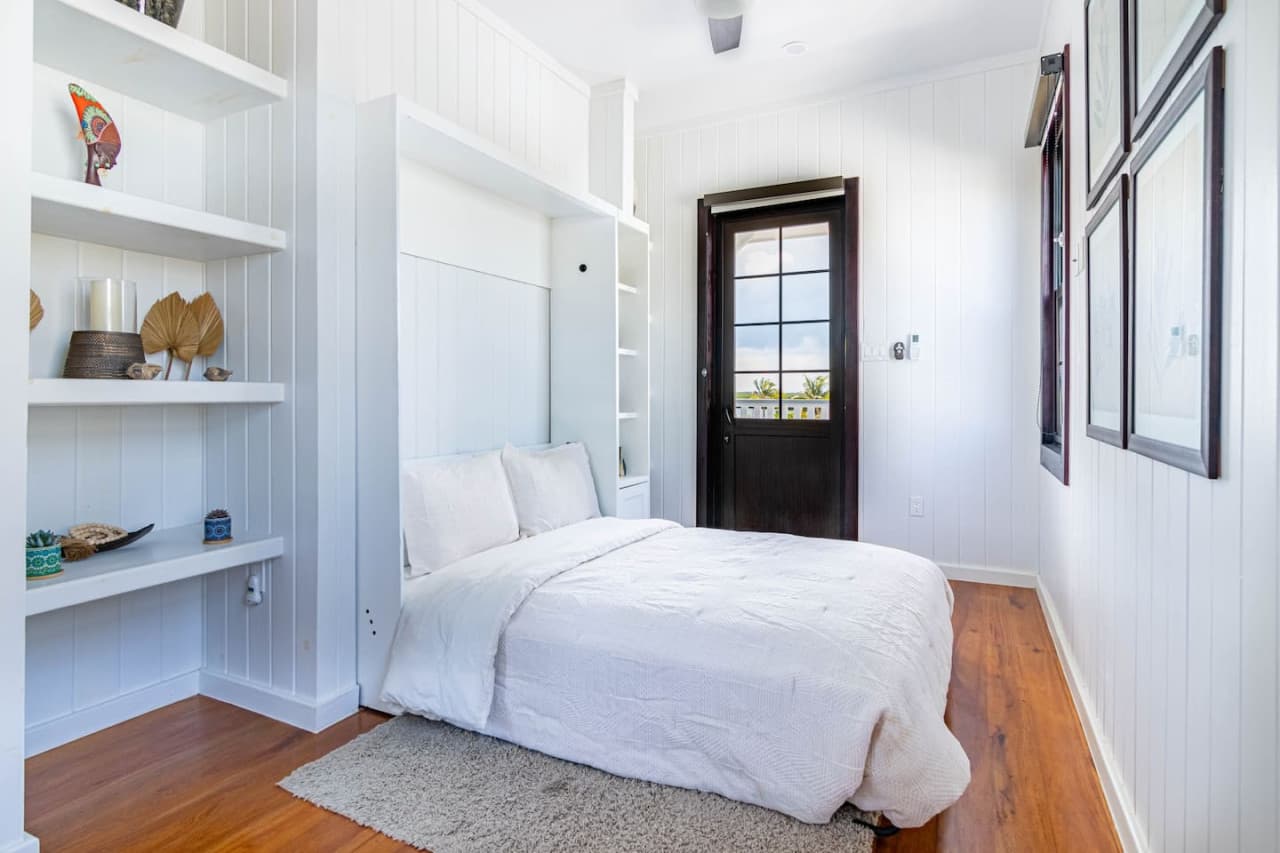 Murphy bed in 2nd floor loft area showing door to balcony.