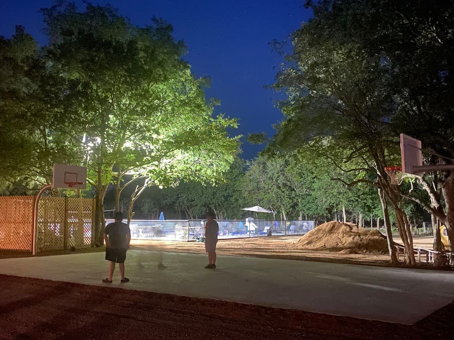 The basketball court is lit up at night!